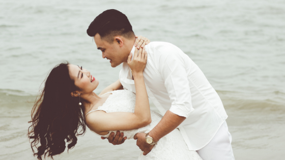 a happy couple by the beach