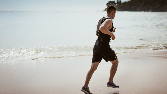 a man jogging by the beach