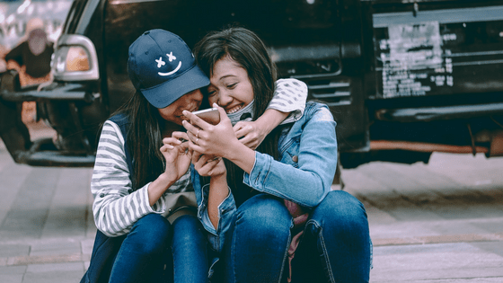 two thai girls using a cellphone